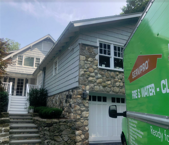 a SERVPRO vehicle parked outside of a house