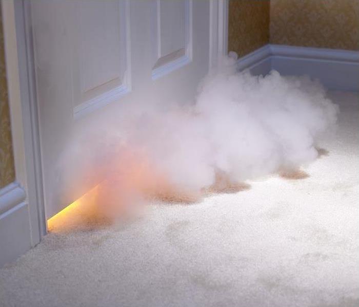smoke entering room under door; flames also seen
